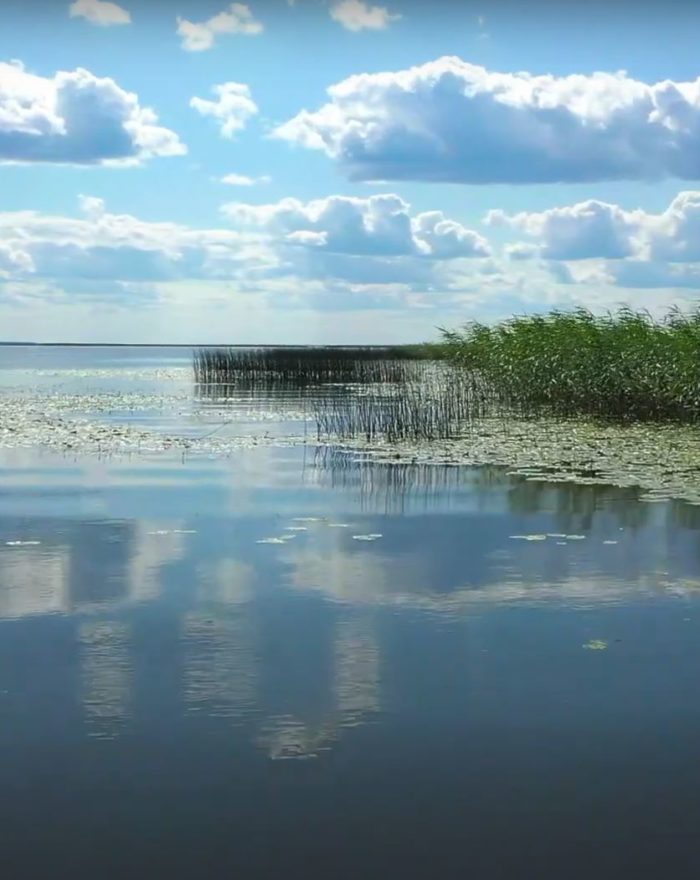 Suncolors, clouds and lake water