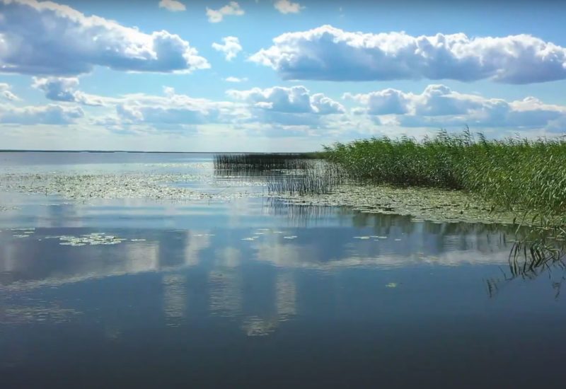 Suncolors, clouds and lake water